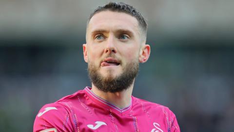 Matt Grimes wearing Swansea's pink third kit