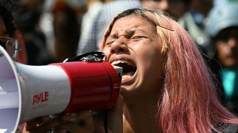 A protester in the US shouts into a megaphone