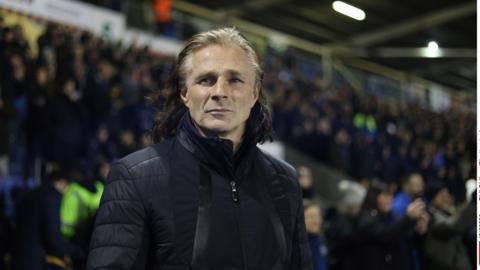 Shrewsbury Town Gareth Ainsworth soaks in the atmosphere at a midweek home game under the lights