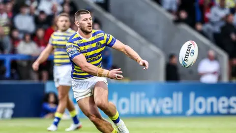 Marc Sneyd of Warrington Wolves passes the ball during the Betfred Super League round 13 match between Warrington Wolves and Hull FC