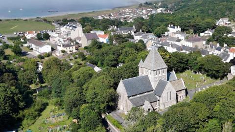 An aerial picture of the church showing its large size and surrounding area. The sea is visible in the background. 