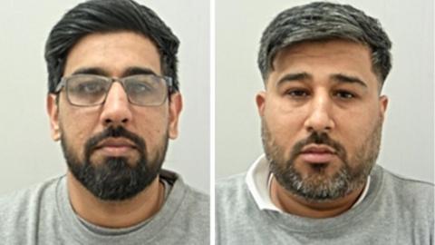 Kashif  Mehdi (L) has dark hair and beard with spectacles. Rizwan Mehdi (R) has greying dark hair and beard. Both are wearing grey prison sweat shirts.