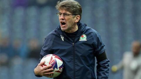 Blackburn caretaker boss David Lowe shouts from the touchline with a football in his hand