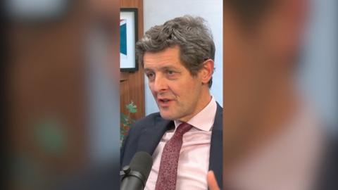 Hugh Pym in the Newscast studio