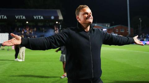 Richie Wellens celebrates with Leyton Orient's fans after beating Stockport County