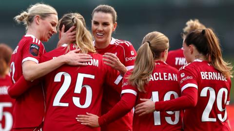 Alice Bergstrom of Liverpool celebrates scoring her team's sixth goal with teammates 
