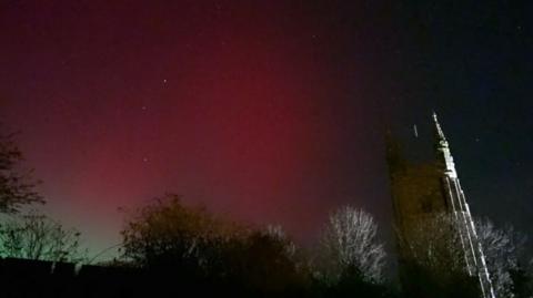 A red glow is seen in the sky.