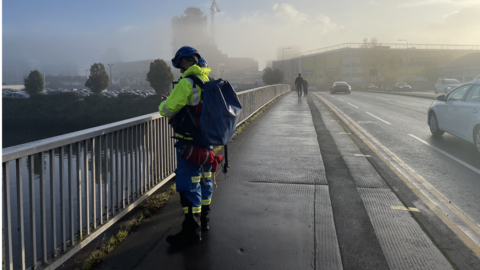 An emergency services worker watches the river