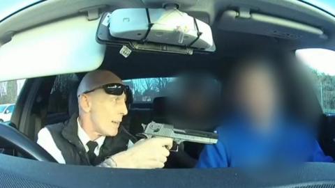 Man holding gun in taxi