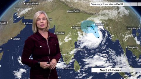 Sarah Keith-Lucas standing in front of a weather map