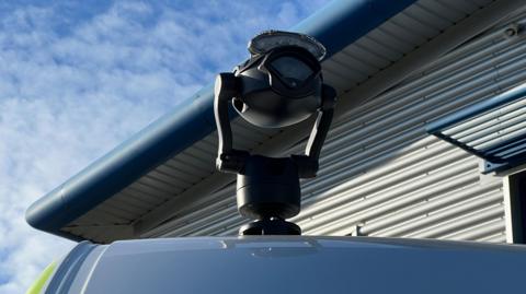 A live facial recognition camera mounted on top of a police van.