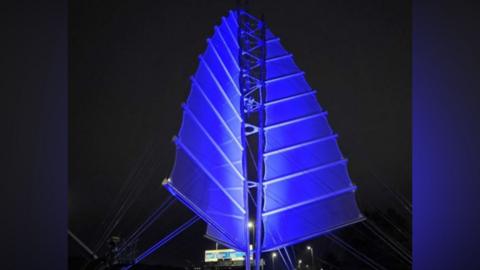 Portsmouth’s Sails of the South sculpture lit up in blue lights.