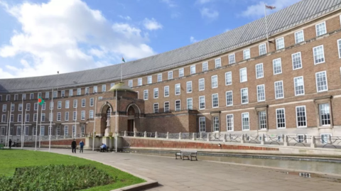 Bristol City Council building, which is made of brown bricks and in a crescent shape. 