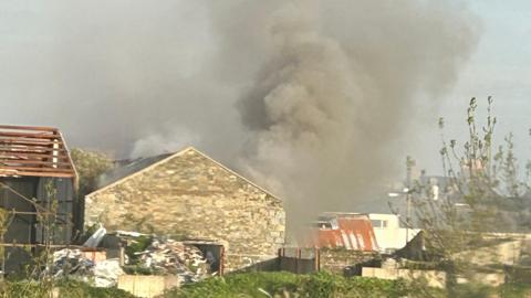 A grey cloud of smoke above the old derelict former Leale's Yard site in Guernsey.