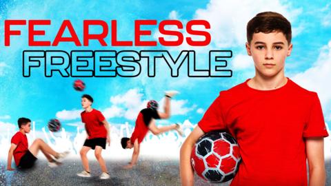 a boy in a red t shirt holds a football in his right arm
