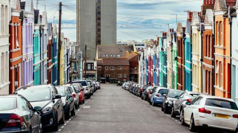 Multi coloured terraced houses on city street in Brighton.