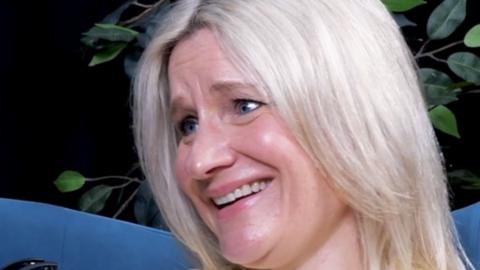 A woman with blonde hair smiling.