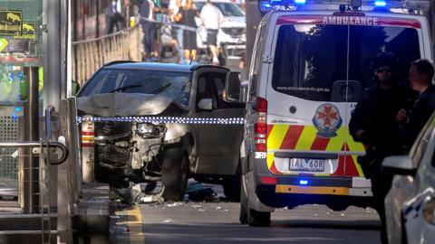 Australian police stand near a crashed vehicle that had ploughed into pedestrians near Flinders Street train station in central Melbourne, Australia, December 21, 2017