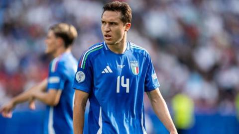 Federico Chiesa looks on while playing for Italy