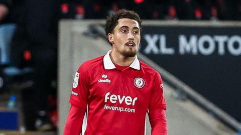 Haydon Roberts standing on the pitch during a match for Bristol City this season