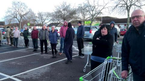 People queue for bottled water