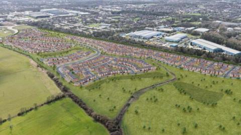 CGI image of overhead shot looking at green fields. A large portion of these fields are taken by rows of houses. 