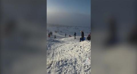People enjoying the snow on Black Mountain, Swansea, a still from a video taken of people using sledges