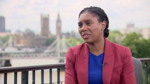 Kemi Badenoch with London skyline view behind her