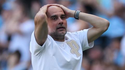 pep guardiola holds his head in his hands