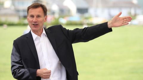 Jeremy Hunt with an outstreched hand