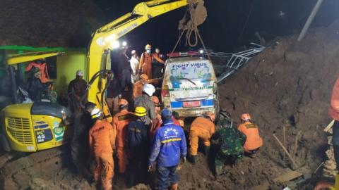 An ambulance is lifted from the mud after it was buried in a landslide in Sumedang, West Java, Indonesia, 9 January 2021