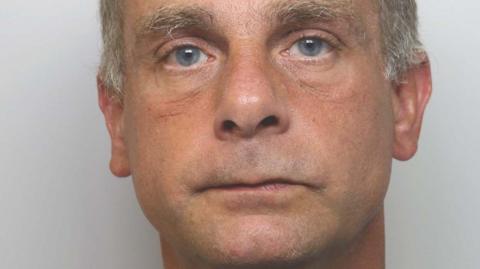 Police custody photograph of Simon Carter looking directly at the camera. He has no expression.