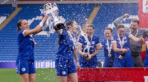 Cardiff City players celebrate with the trophy 