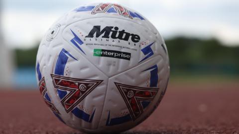 A National League football on an athletics track