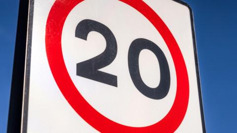 The number 20 in black on a white background and in a red circle.