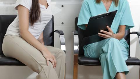 A woman and a nurse in a waiting room