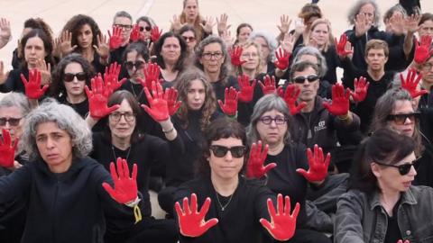 Hostage families with red painted hands in Tel Aviv, Israel
