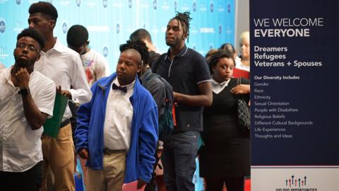 Job seekers arrive at the Walter E. Washington Convention Center for The Opportunity Hiring Fair in Washington, DC, on September 20, 2017
