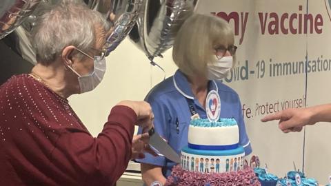 Ann Allen cutting the anniversary cake