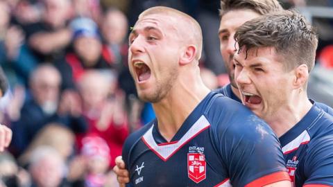 Mikey Lewis celebrates his try on England debut