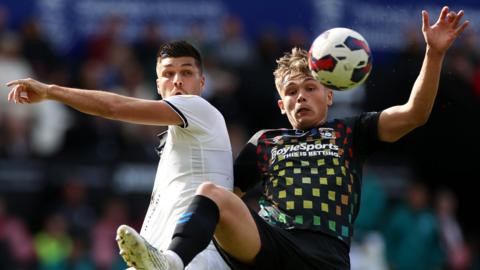 Swansea's Joel Piroe battles with Callum Doyle