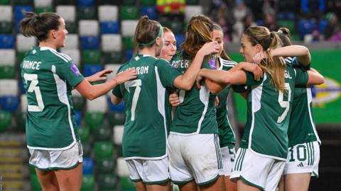 Northern Ireland players celebrate after scoring against Montenegro