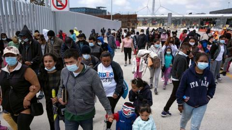 Migrants attend a demonstration at the San Ysidro crossing port asking US authorities to allow them to start their migration process in Tijuana, Baja California state, Mexico on March 23, 2021