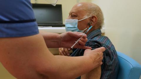 Dr Hari Shukla receiving the Pfizer/BioNTech vaccine