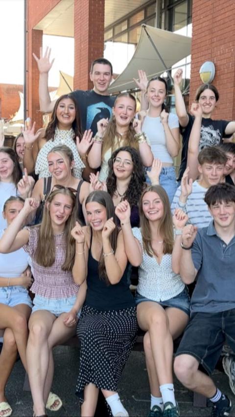 Groups of A-level pupils celebrating their results