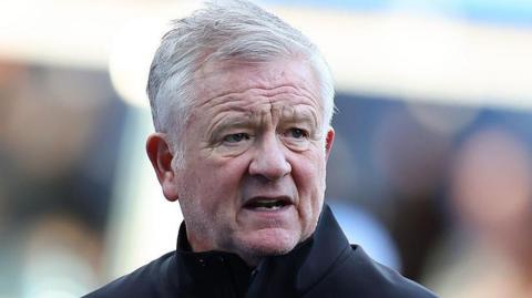 Sheffield United boss Chris Wilder head shot looking concerned, wearing black jacket