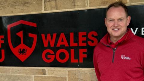 Performance director Gareth Jenkins alongside a Wales Golf sign