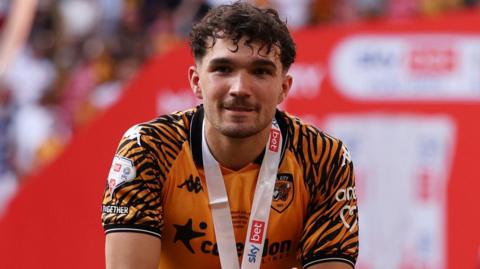 Kyle Joseph, wearing Hull City's amber and black kit, pictured at Wembley Stadium with a medal around his neck after Hull beat Middlesbrough in the Championship play-off final