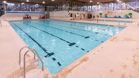 The inside of an empty public swimming pool