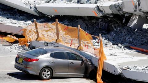 Damaged car under bridge